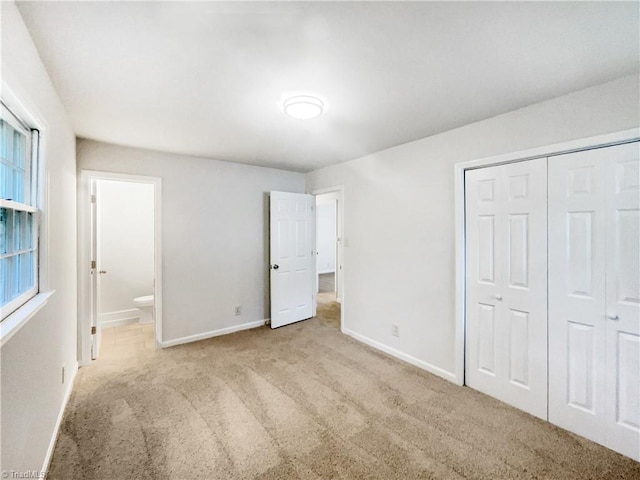 1606 Woodbriar Ave, Greensboro, NC 27405 - unfurnished bedroom featuring carpet flooring, a closet, and ensuite bath