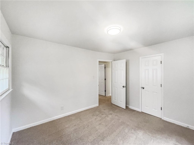 1606 Woodbriar Ave, Greensboro, NC 27405 - unfurnished bedroom with carpet flooring and baseboards