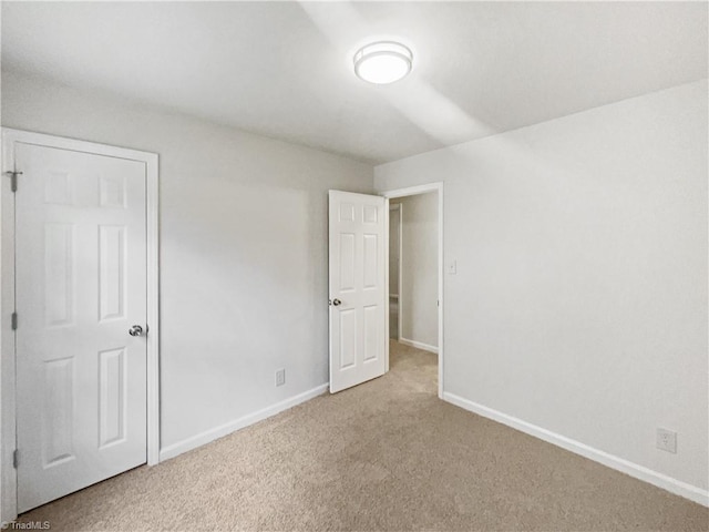 1606 Woodbriar Ave, Greensboro, NC 27405 - unfurnished bedroom with carpet flooring and baseboards