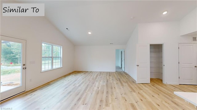 unfurnished living room with light hardwood / wood-style floors and lofted ceiling