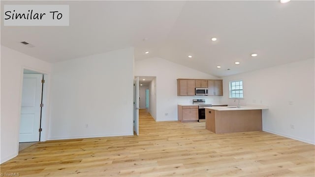 kitchen featuring kitchen peninsula, light hardwood / wood-style flooring, stainless steel appliances, lofted ceiling, and sink