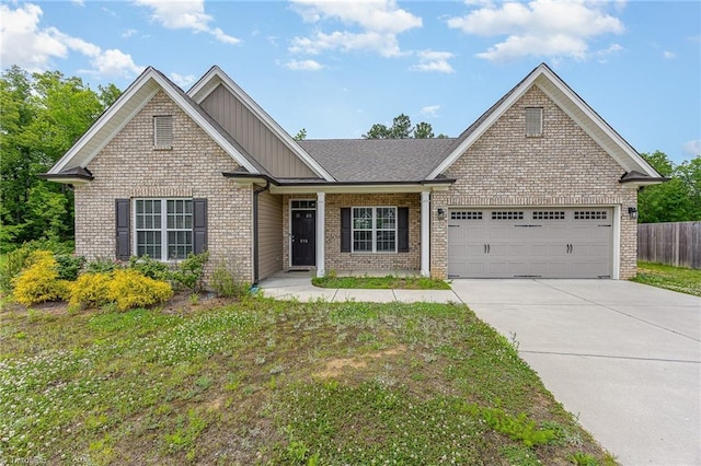 275 Obsidium Ct, Gibsonville, NC 27249 - view of front of house featuring board and batten siding, driveway, a garage, and brick siding