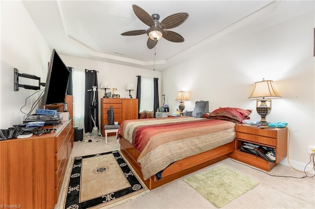 275 Obsidium Ct, Gibsonville, NC 27249 - bedroom featuring a raised ceiling, light colored carpet, a ceiling fan, and baseboards