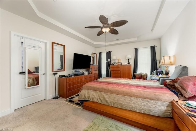 275 Obsidium Ct, Gibsonville, NC 27249 - carpeted bedroom with a tray ceiling, baseboards, and ceiling fan