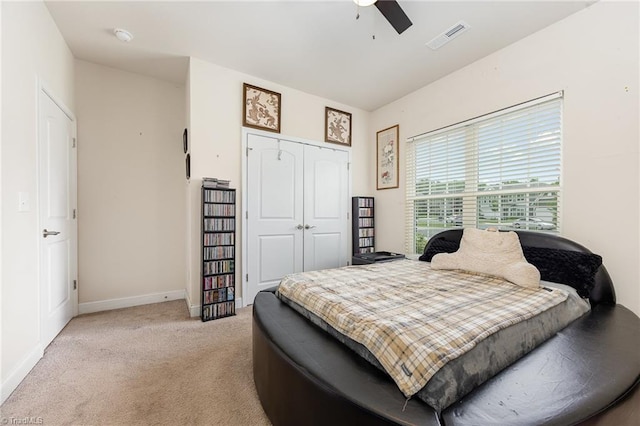 275 Obsidium Ct, Gibsonville, NC 27249 - bedroom featuring light carpet, a closet, baseboards, and a ceiling fan