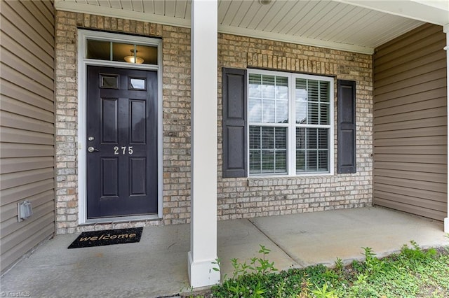 275 Obsidium Ct, Gibsonville, NC 27249 - entrance to property with covered porch and brick siding