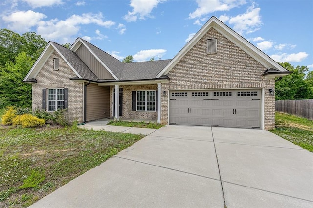 275 Obsidium Ct, Gibsonville, NC 27249 - view of front of home with an attached garage, driveway, brick siding, board and batten siding, and a shingled roof