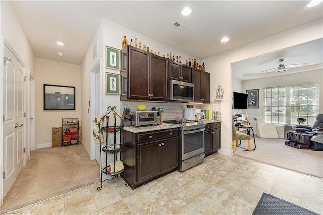275 Obsidium Ct, Gibsonville, NC 27249 - kitchen with appliances with stainless steel finishes, dark brown cabinets, baseboards, light colored carpet, and recessed lighting