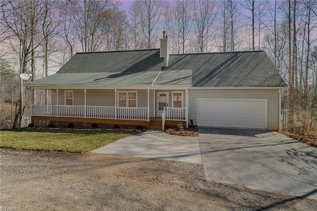 view of front facade featuring driveway, a chimney, roof with shingles, an attached garage, and a porch