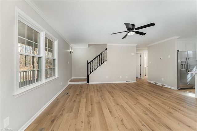 unfurnished living room featuring crown molding, visible vents, stairway, light wood-type flooring, and baseboards