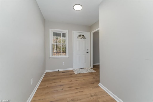 entryway featuring light wood-style flooring and baseboards