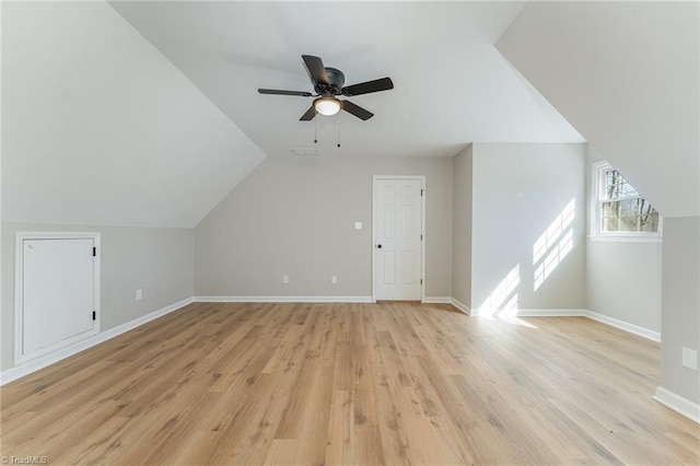 bonus room with lofted ceiling, visible vents, ceiling fan, light wood-type flooring, and baseboards