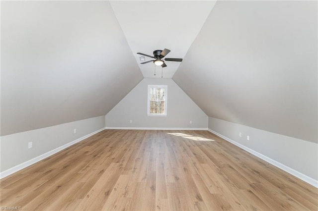 bonus room with a ceiling fan, lofted ceiling, light wood-style flooring, and baseboards