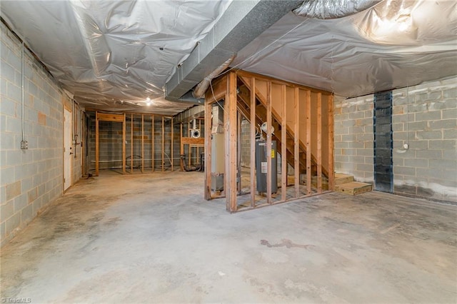 unfinished below grade area with concrete block wall and water heater