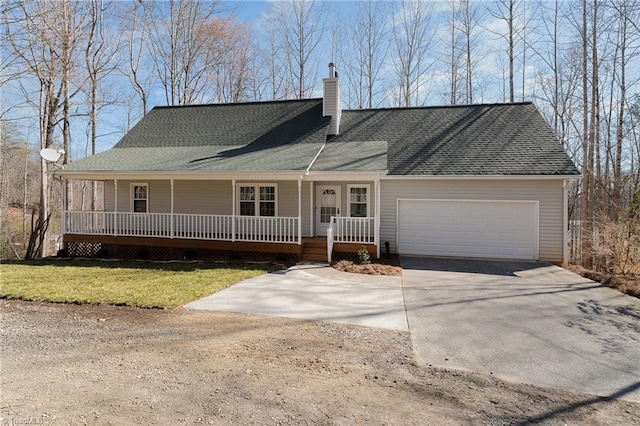 view of front of house featuring a porch, an attached garage, concrete driveway, a front lawn, and a chimney