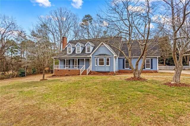 view of front facade with a front yard and covered porch