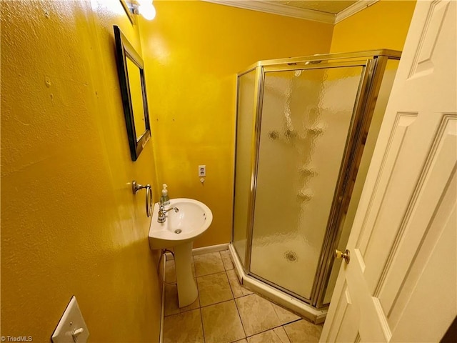 bathroom featuring a shower with door, ornamental molding, and tile patterned floors