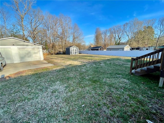 view of yard with a garage and a shed