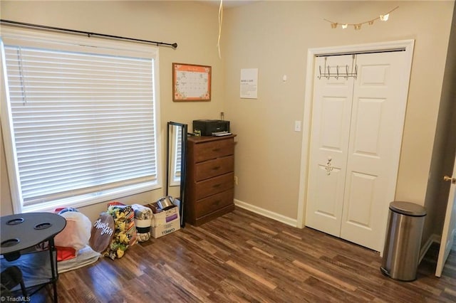 recreation room featuring dark wood-type flooring and baseboards