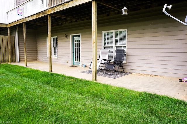 back of house with a patio, a yard, and a wooden deck
