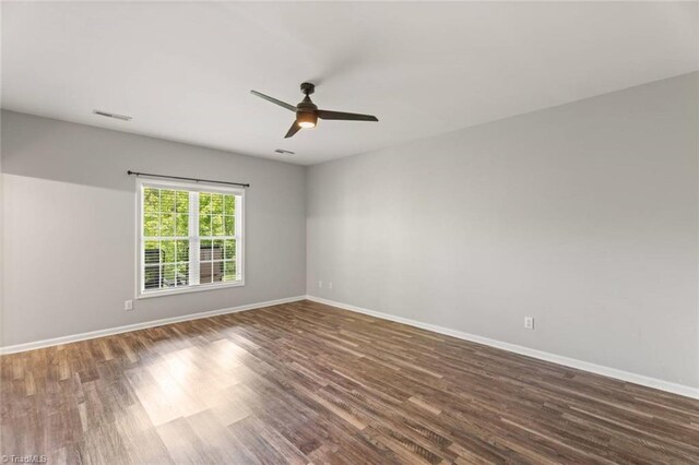 226 Lola Ln Unit 102, Pilot Mountain, NC 27041 - spare room featuring wood finished floors, baseboards, and a ceiling fan