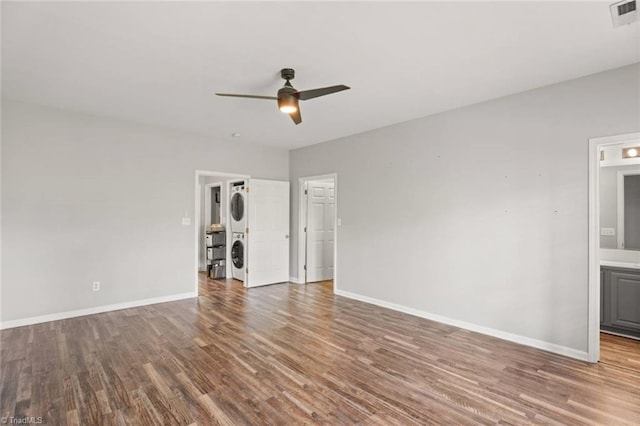 226 Lola Ln Unit 102, Pilot Mountain, NC 27041 - empty room with estacked washer and dryer, ceiling fan, wood finished floors, and baseboards