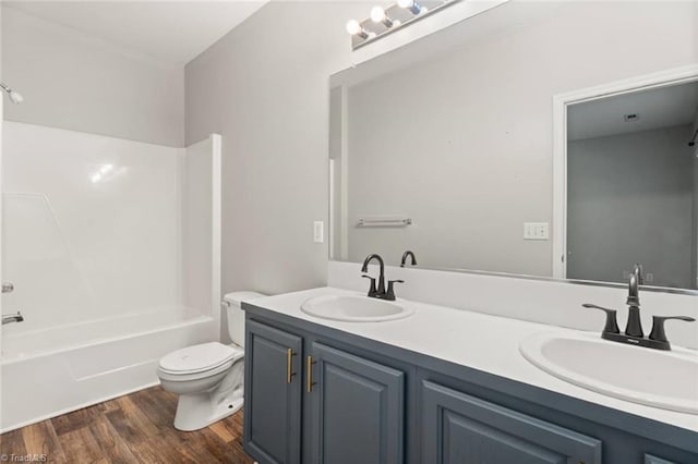 226 Lola Ln Unit 102, Pilot Mountain, NC 27041 - bathroom featuring wood finished floors, double vanity, toilet, and tub / shower combination