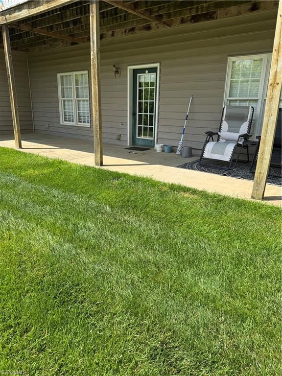exterior space featuring a patio and a lawn