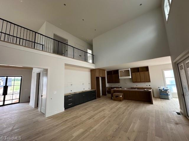 1341 Maple Chase Ln, Winston-Salem, NC 27106 - kitchen with a high ceiling, light wood-type flooring, open floor plan, and a kitchen island