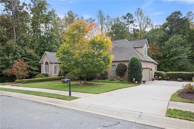 view of front of home with a front yard and a garage