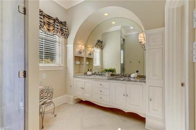 bathroom featuring crown molding, tile patterned floors, vanity, and walk in shower