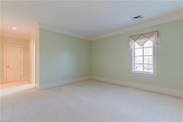 spare room featuring light colored carpet and ornamental molding