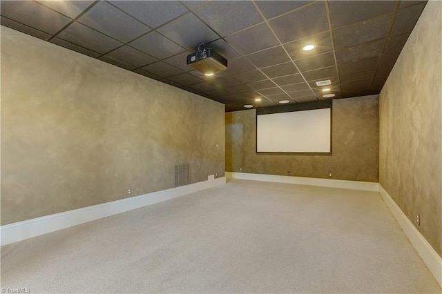 cinema room featuring carpet flooring and a drop ceiling