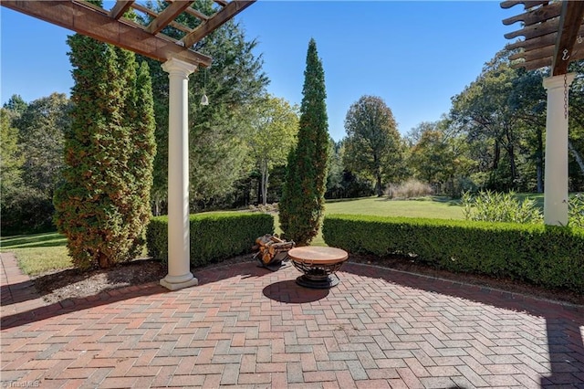 view of patio / terrace with a pergola and a fire pit