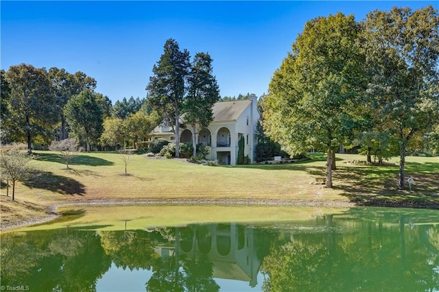 view of home's community featuring a water view and a lawn