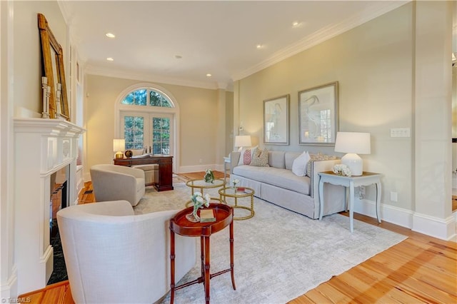 living room with ornamental molding and hardwood / wood-style floors