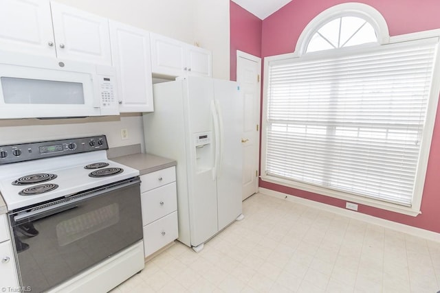 2221314 Delaney Dr, Burlington, NC 27215 - kitchen featuring white appliances, white cabinets, light countertops, and baseboards