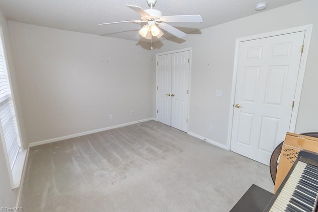 2221314 Delaney Dr, Burlington, NC 27215 - unfurnished bedroom featuring light colored carpet, a closet, baseboards, ceiling fan, and a textured ceiling