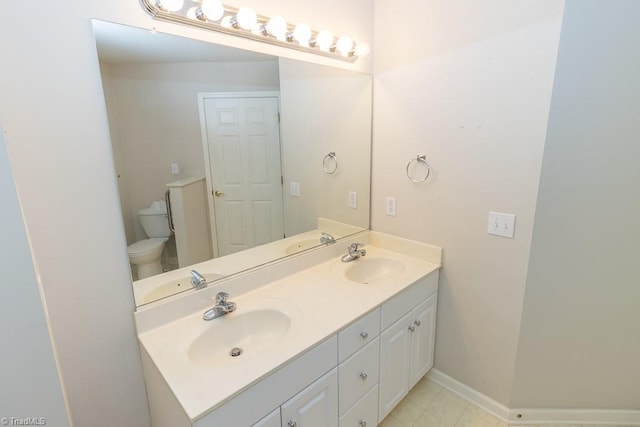 2221314 Delaney Dr, Burlington, NC 27215 - bathroom featuring toilet, double vanity, and baseboards