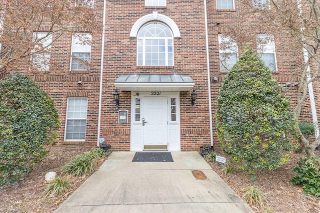 2221314 Delaney Dr, Burlington, NC 27215 - view of exterior entry with brick siding and a standing seam roof