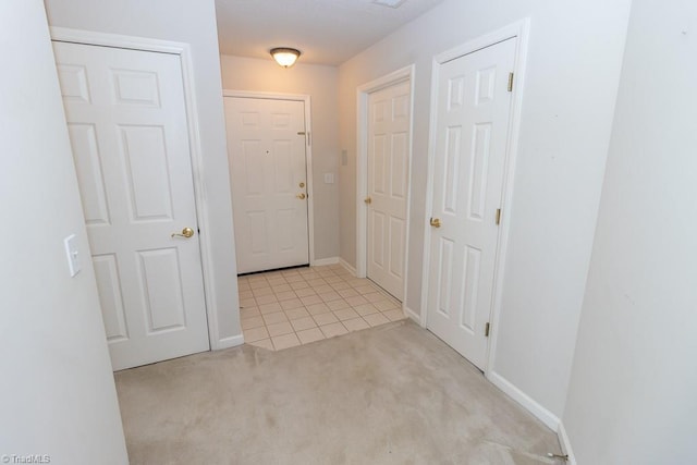 2221314 Delaney Dr, Burlington, NC 27215 - hall with carpet, baseboards, and tile patterned flooring