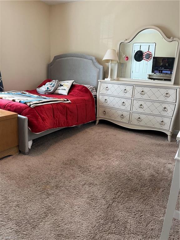 bedroom featuring carpet