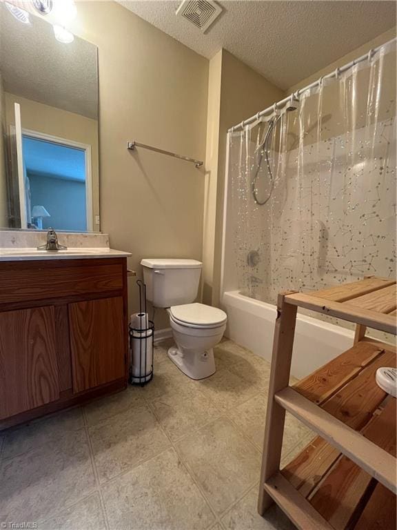 full bathroom featuring shower / bath combination with curtain, tile patterned flooring, vanity, toilet, and a textured ceiling