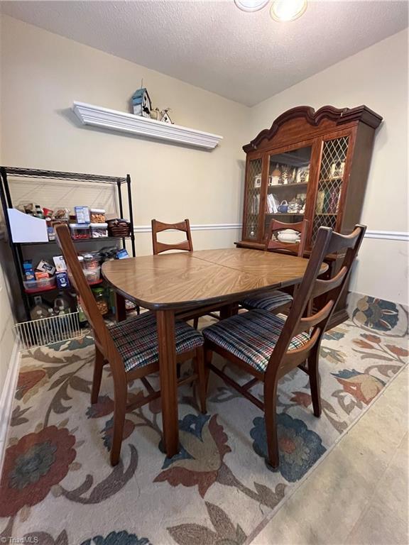 dining space featuring a textured ceiling