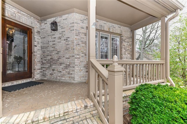 doorway to property featuring brick siding