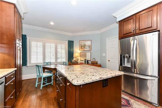 kitchen featuring light stone counters, stainless steel appliances, and crown molding