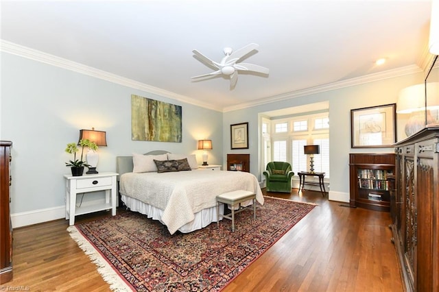 bedroom featuring crown molding, baseboards, and wood finished floors