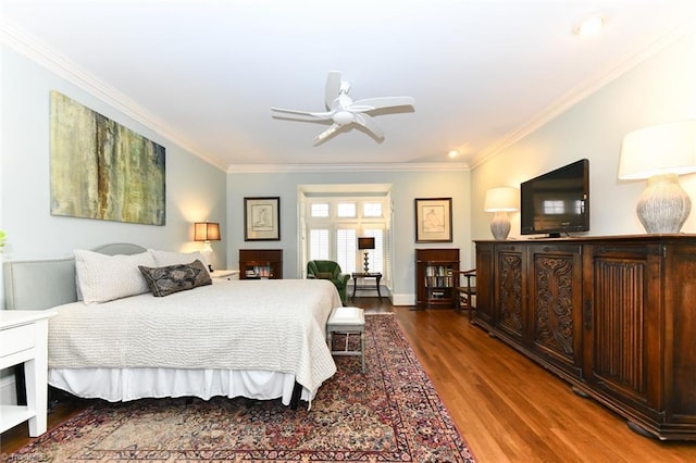 bedroom featuring ornamental molding, baseboards, and wood finished floors