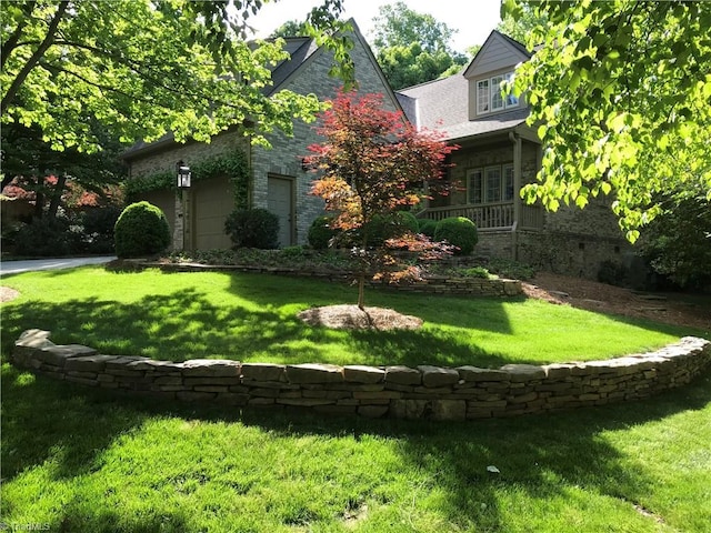 exterior space featuring a yard and a garage