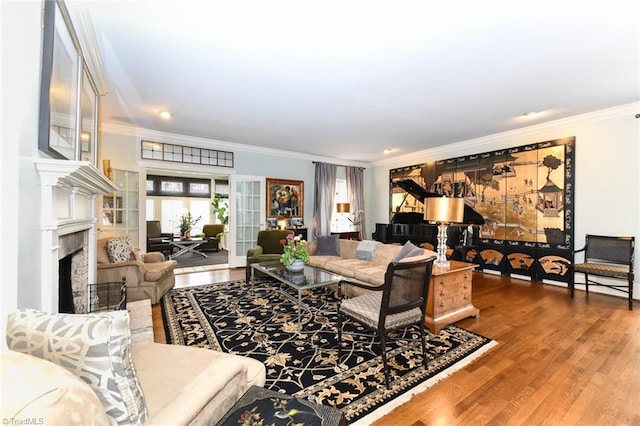 living room featuring a fireplace, crown molding, french doors, and wood finished floors